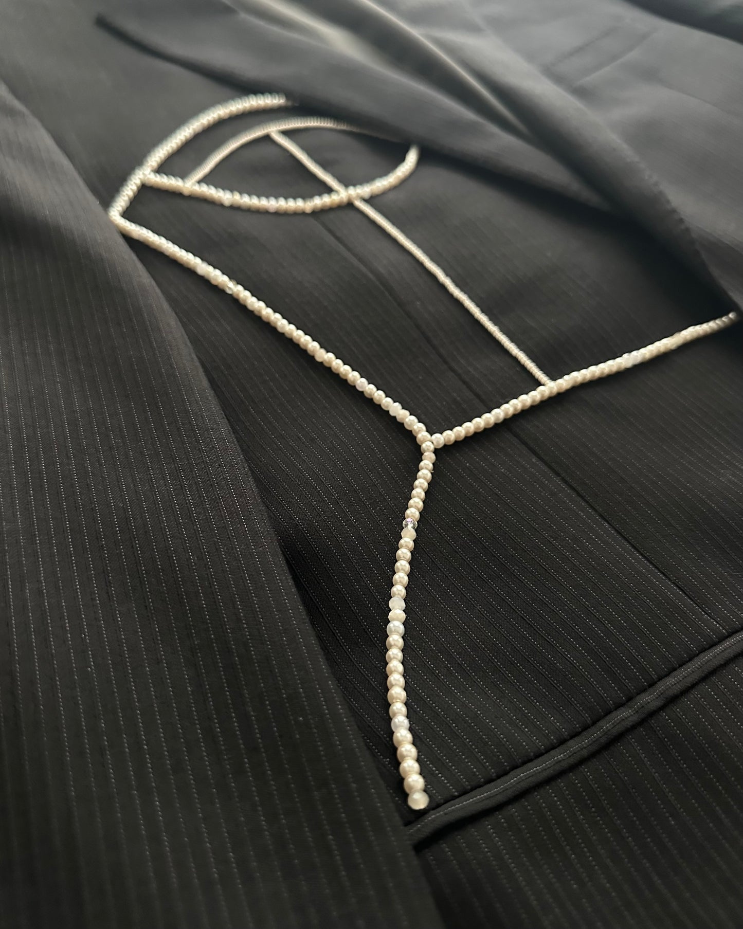 BLACK PINSTRIPE WOOL BLAZER WITH HAND-BEADED CORSET DESIGN